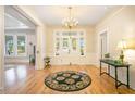 Elegant foyer with hardwood floors, chandelier, and decorative rug at 102 Whitaker St, Franklinton, NC 27525