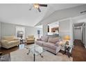 Bright and airy living room showcases a vaulted ceiling, hardwood floors, and neutral paint at 103 Willoughby Ln, Cary, NC 27513