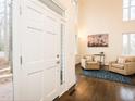 Bright foyer showcasing hardwood floors, two-story ceilings, and a glimpse into the adjacent living space at 104 Manchester Pl, Chapel Hill, NC 27516