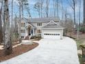 Charming two-story home features a paved driveway, attached garage, and beautiful natural surroundings at 104 Manchester Pl, Chapel Hill, NC 27516