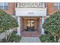 Welcoming entrance with brick walkway, columns, and meticulously maintained landscaping for a great first impression at 10421 Rosegate Ct # 303, Raleigh, NC 27617