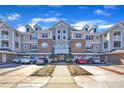 Attractive multi-story condo building with well-maintained landscaping, individual driveways, and convenient parking spaces for residents at 10421 Rosegate Ct # 303, Raleigh, NC 27617