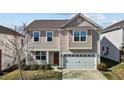 Charming home featuring neutral siding, an attached two-car garage, and a cozy front porch at 1055 Kerr St, Burlington, NC 27215