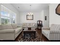 Bright living room with neutral tones, a decorative rug, and comfortable seating, perfect for relaxation and entertaining guests at 1055 Kerr St, Burlington, NC 27215
