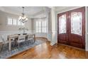 Elegant dining room featuring hardwood floors, stylish chandelier, and beautiful trim work at 1086 Tender Dr, Apex, NC 27502