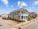 Corner lot showcasing a charming two-story home with double porches and manicured landscaping at 1086 Tender Dr, Apex, NC 27502