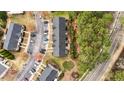 Aerial view of townhome community surrounded by mature trees and parking areas at 116 Anterbury Dr, Apex, NC 27502