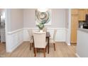 Cozy dining area featuring elegant wainscoting, modern lighting, and stylish table setting at 1301 Durlain Dr # 108, Raleigh, NC 27614