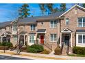 Brick townhomes featuring uniform architectural details and well-maintained landscaping at 138 Tressel Way, Durham, NC 27707