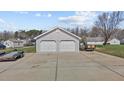 Detached two-car garage with wide concrete parking pad provides ample parking at 1408 Harvey Johnson Rd, Raleigh, NC 27603