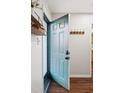 Open entryway with wood floors, coat hooks and view of kitchen at 1515 Edgeside Ct, Raleigh, NC 27609