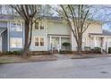 Inviting townhome with a cozy entrance, front porch and trees creating curb appeal at 1515 Edgeside Ct, Raleigh, NC 27609