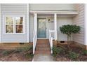 Front porch with decorative door, brick steps and landscaped bushes at 1515 Edgeside Ct, Raleigh, NC 27609