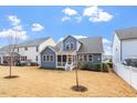 Expansive backyard with lush green grass and a charming home with blue siding at 1564 Highpoint St, Wake Forest, NC 27587