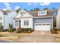 Charming two-story home featuring a two-car garage, complemented by a landscaped yard and inviting curb appeal at 1564 Highpoint St, Wake Forest, NC 27587