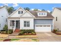 Inviting home exterior with a well-kept lawn and a two-car garage under a clear sky at 1564 Highpoint St, Wake Forest, NC 27587