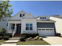 Beautiful single-Gathering home with a well-maintained lawn, complemented by vibrant landscaping and a cozy front porch at 1564 Highpoint St, Wake Forest, NC 27587