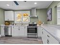 Charming kitchen showcasing stainless steel appliances and crisp white cabinetry at 1855 W West River Rd, Franklinton, NC 27525