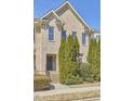 Two-story brick townhome features a well-manicured front yard and inviting front entrance at 203 Valleyshire Rd, Durham, NC 27707