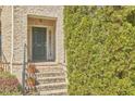 Close up of a brick front entrance featuring a front door, stairs, and seasonal landscaping at 203 Valleyshire Rd, Durham, NC 27707