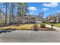 Traditional brick home with a two-car garage, lovely landscaping and a large front yard at 207 Lewey Brook Dr, Cary, NC 27519