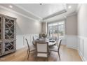 Charming dining area with wainscoting, a round table, and stylish decor at 2073 Amalfi Pl, Apex, NC 27502