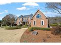 Charming brick home featuring detailed landscaping and a welcoming, well-maintained lawn at 212 Whirlaway Ln, Chapel Hill, NC 27516