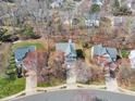 Overhead view of a neighborhood featuring mature trees, well-kept lawns, and paved streets at 2418 Summit Dr, Hillsborough, NC 27278