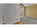 Inviting entryway with a view into a sunlit room featuring a bay window at 2418 Summit Dr, Hillsborough, NC 27278