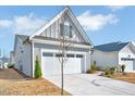 Lovely single-story home featuring a two-car garage, gray siding, and well-kept landscaping at 244 Mahogany Run, Raleigh, NC 27610