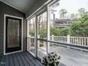 Relaxing screened porch with outdoor views and a door to the inside of the home at 27 Kings Mount Ct, Durham, NC 27713
