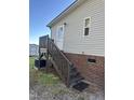 Image of the home's side entrance featuring stairs and a small wooden deck area at 30 Jamestown Ct Ct, Zebulon, NC 27597