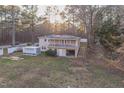 View of the home's back exterior with a balcony and stairs leading to the backyard at 3012 Optimist Farm Rd, Apex, NC 27539