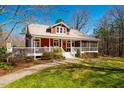 Attractive two-story home with a metal roof, a quaint front porch, and mature landscaping at 3227 Morrow Farm Ln, Chapel Hill, NC 27516