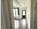 Inviting hallway featuring wood flooring, neutral walls, and seamless flow to the dining area at 49 W Copenhaver Dr, Clayton, NC 27527