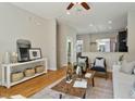 Open-concept living room showcasing hardwood floors and modern decor with an eat-in kitchen at 500 John Haywood Way # 103, Raleigh, NC 27604