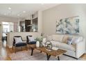 Open-concept living room showcasing hardwood floors and modern decor with an eat-in kitchen at 500 John Haywood Way # 103, Raleigh, NC 27604
