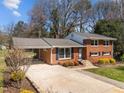 Beautiful red brick home with an attached carport and landscaped front yard at 5108 Melbourne Rd, Raleigh, NC 27606