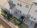 A quaint backyard with a patio, table, chairs, and a partial fence at 517 Aronia Dr, Hillsborough, NC 27278