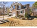 Charming townhome with a stone and siding exterior, attached garage, and lovely front yard landscaping at 5433 Jessip St, Morrisville, NC 27560