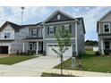 Inviting exterior view of a well-maintained two-story home with a two-car garage and nice lawn at 712 Swim Cave Ln, Wendell, NC 27591