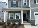 Charming front porch with stone accents and white columns. Address number 712 clearly displayed at 712 Swim Cave Ln, Wendell, NC 27591