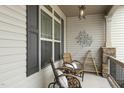 Charming covered front porch featuring comfortable seating and decor at 73 Vibernum Vw, Four Oaks, NC 27524