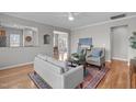 Inviting living room with hardwood floors, ceiling fan, and neutral decor at 734 Hornchurch Loop, Cary, NC 27519