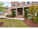 Inviting brick front porch with stately columns, manicured landscaping, and a double-door entryway at 832 Mountain Vista Ln, Cary, NC 27519
