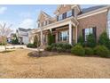 Charming front yard with manicured shrubs and a glimpse of the brick facade at 832 Mountain Vista Ln, Cary, NC 27519