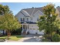 Charming two-story home with a welcoming porch, tidy landscaping, and a two-car garage at 957 Vandalia Dr, Cary, NC 27519