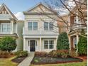 Inviting two-story home with a lovely balcony, manicured landscaping, and classic architectural details at 992 Ambergate, Apex, NC 27502