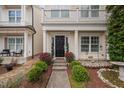 Inviting entrance with manicured shrubbery lining the walkway leading to the front door at 992 Ambergate, Apex, NC 27502