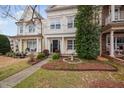 Two story home featuring manicured landscaping, bird bath, and welcoming walkway at 992 Ambergate, Apex, NC 27502